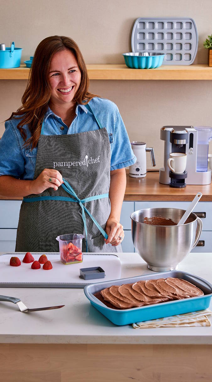a consultant wearing a pamepred chef apron working in a kitchen