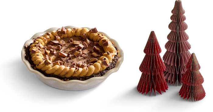 chocolage peanut butter pie in the fully glazed stoneware pie pan and some decorative paper pine trees