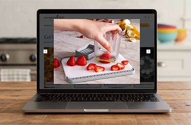 A laptop computer open and showing a Pampered Chef product