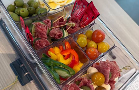 people holding a full snacklebox
